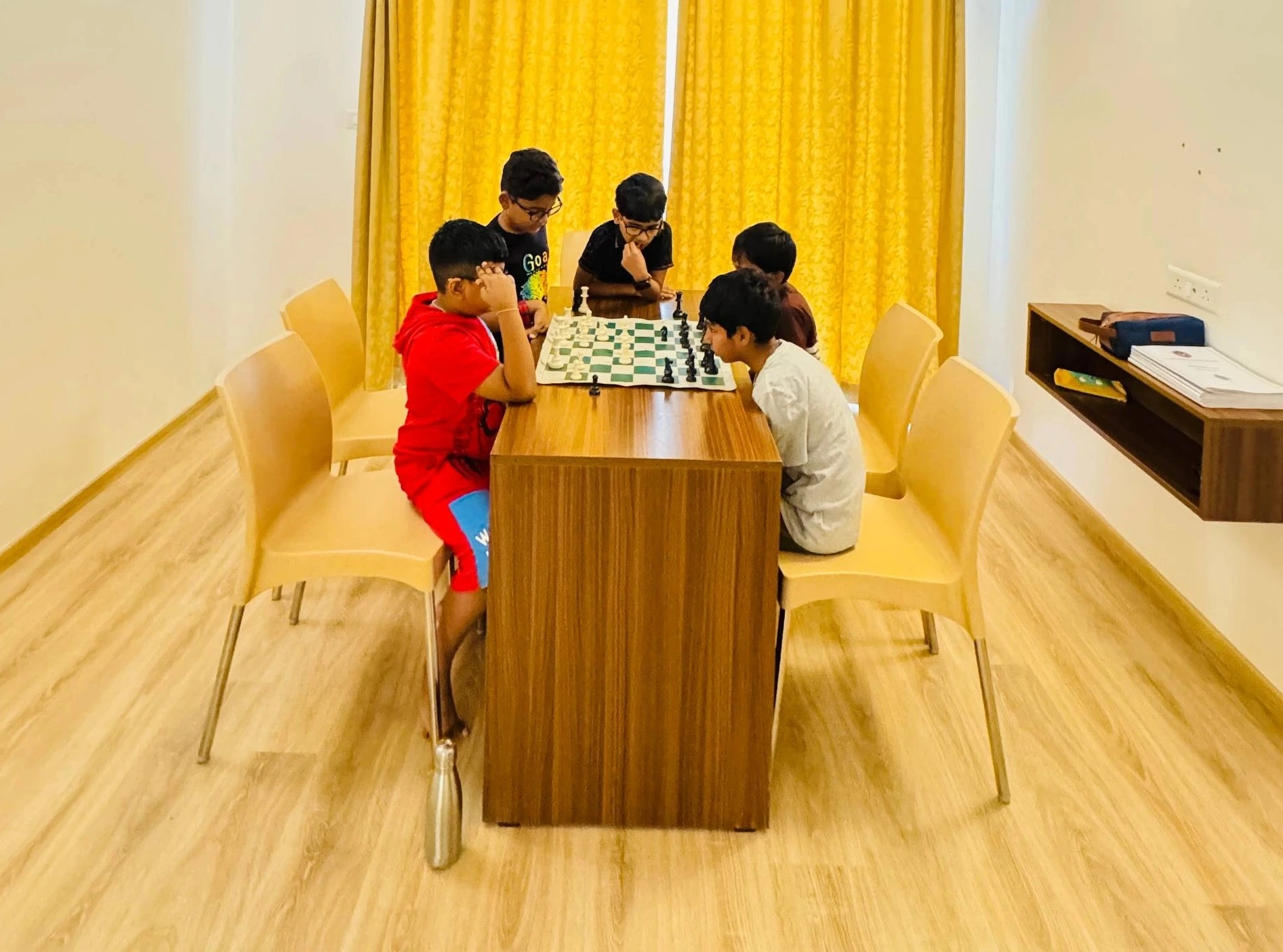 Group of kids practicing chess