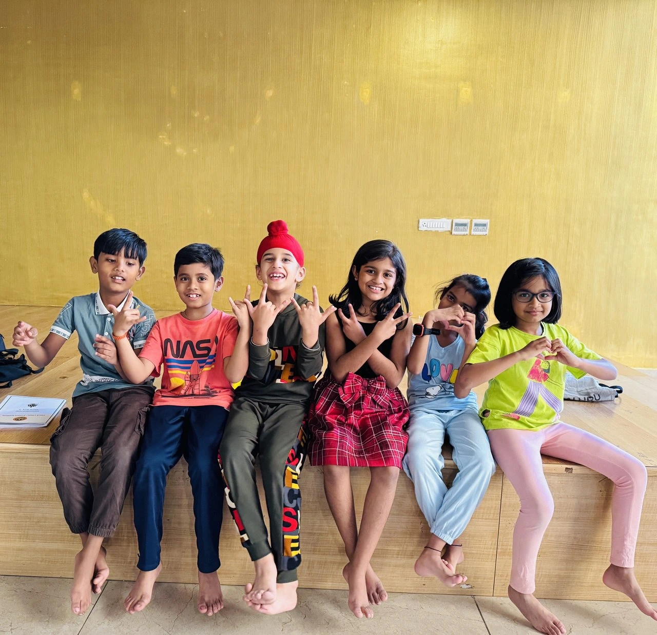 Students enjoying fun time after chess session with a group dance pose