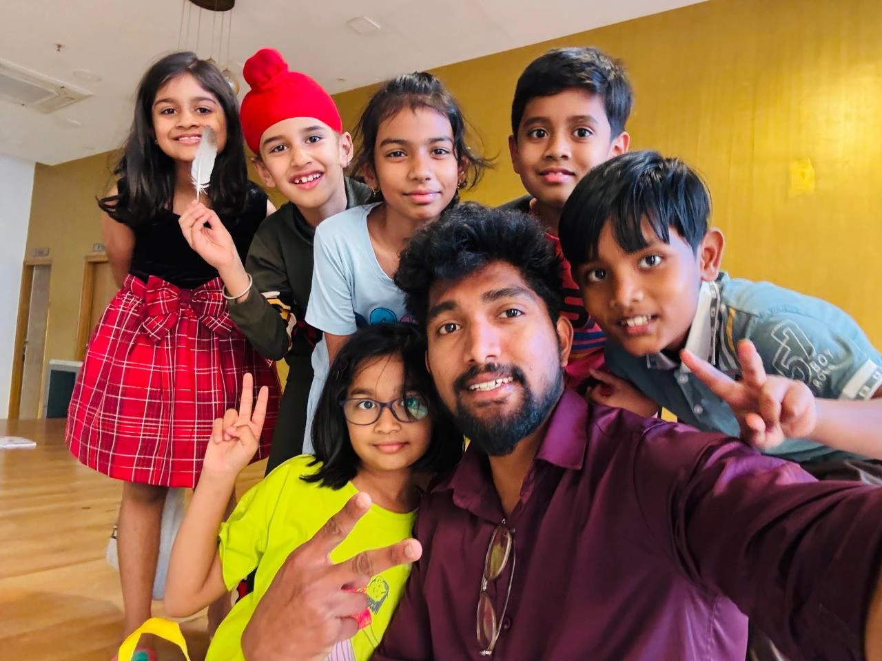 Group selfie of chess students and coach at GKS Academy